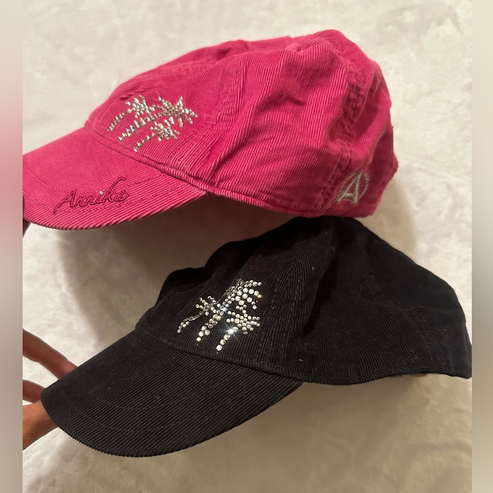 2 NEW ladies caps. Reunion Resort palm tree logo in rhinestones. Pink & black